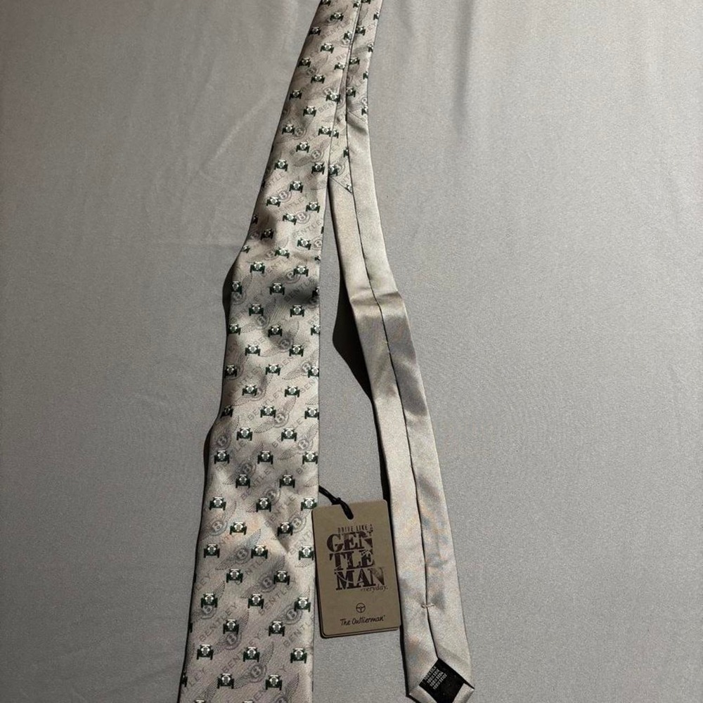 'The Outlierman Bentley Silver Tie with repeating green car logos'